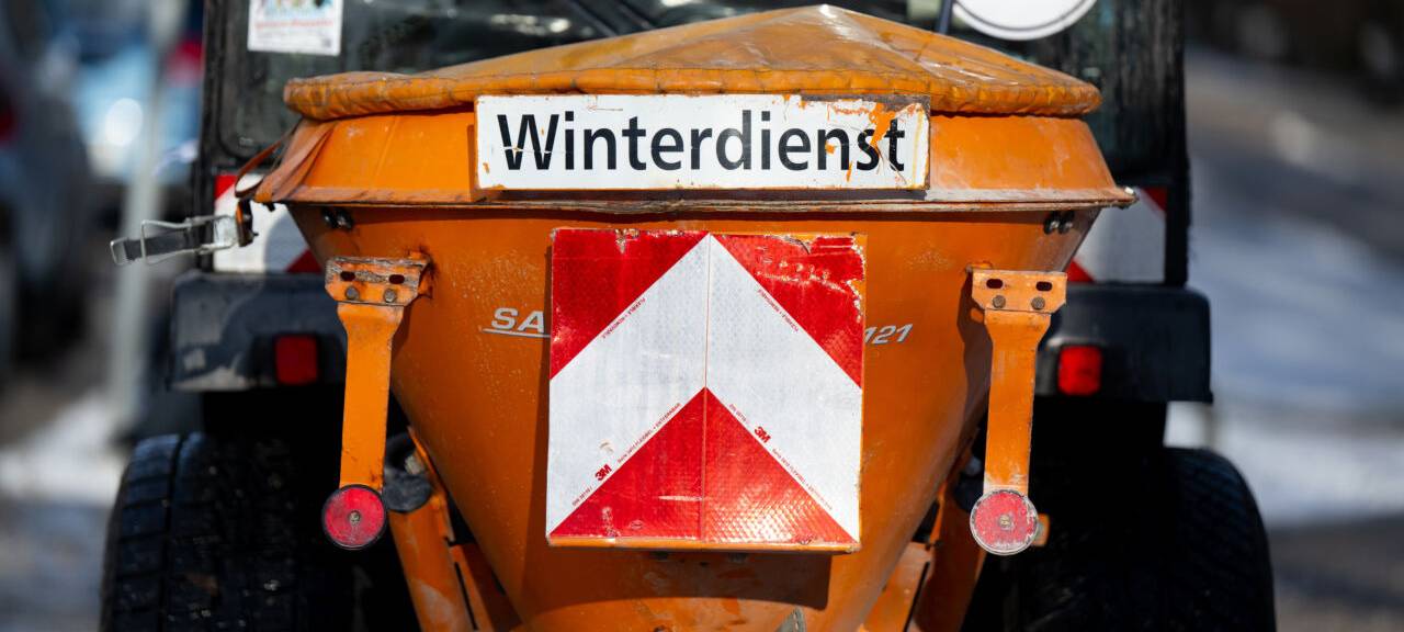 Ein Schneeräumfahrzeug vom Winterdienst der Stadt München steht auf einem Fußweg.